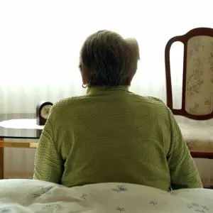 Eine Seniorin in ihrem Schlafzimmer