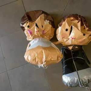 Luftballons in Form eines Brautpaars hängen an einer Decke