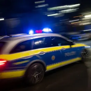 Ein Polizeiauto fährt mit Blaulicht zum Einsatz.